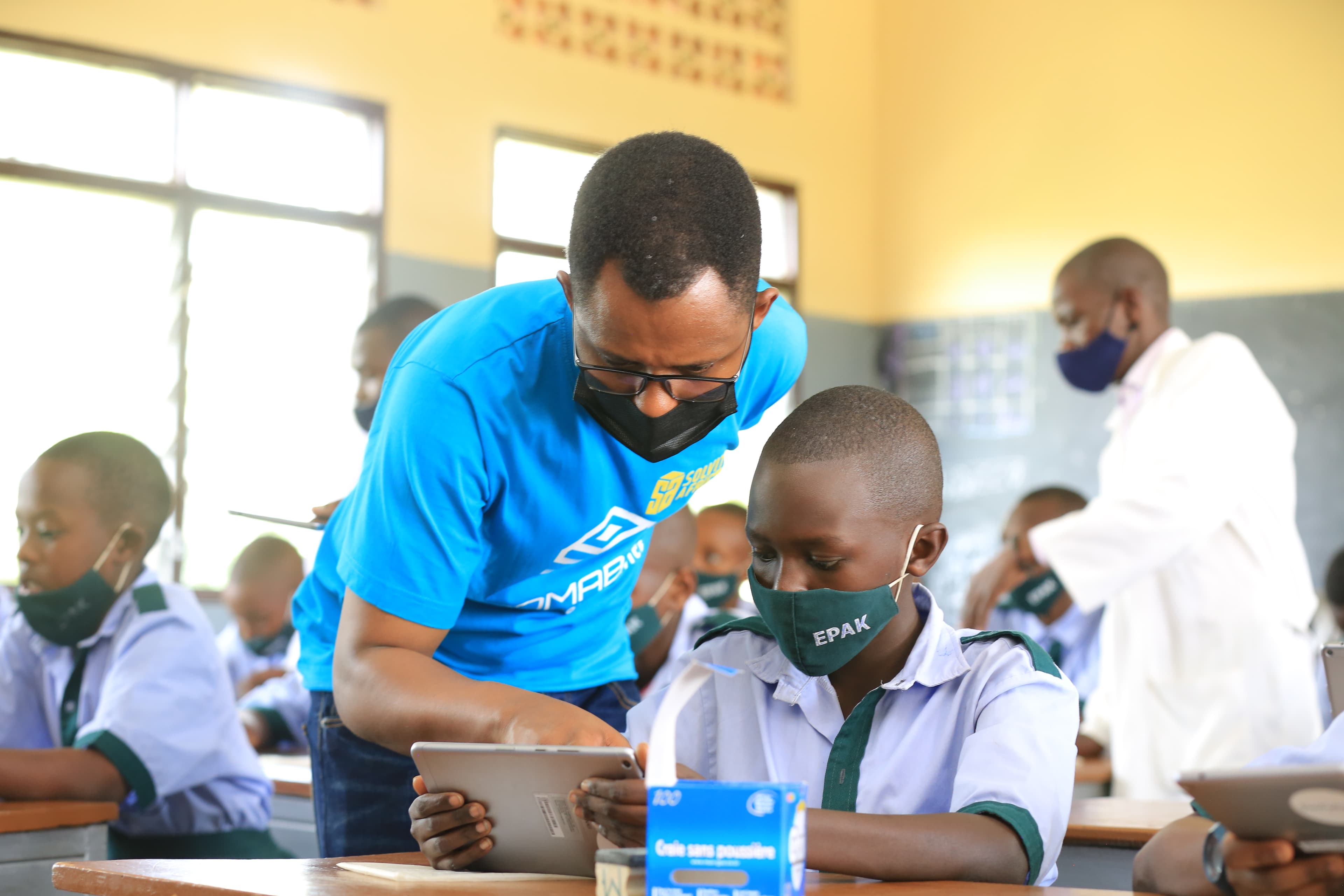 Soma Foundation Rwanda Founder showing a student how to use SomaBox